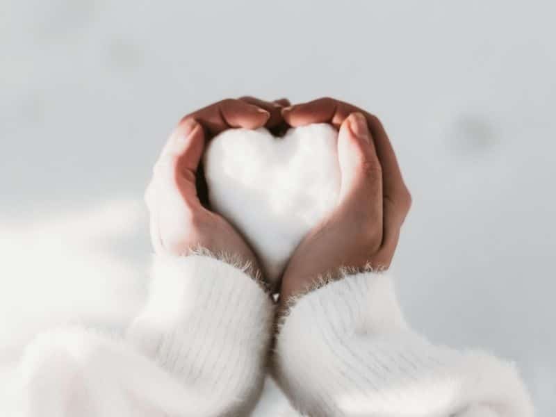hands holding a heart made from snow - kindness quotes